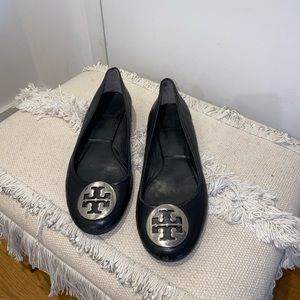Black leather Tory Burch flats with silver logo